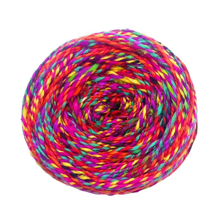 Vibrant yarn ball with bold red, pink, green, and yellow swirls.