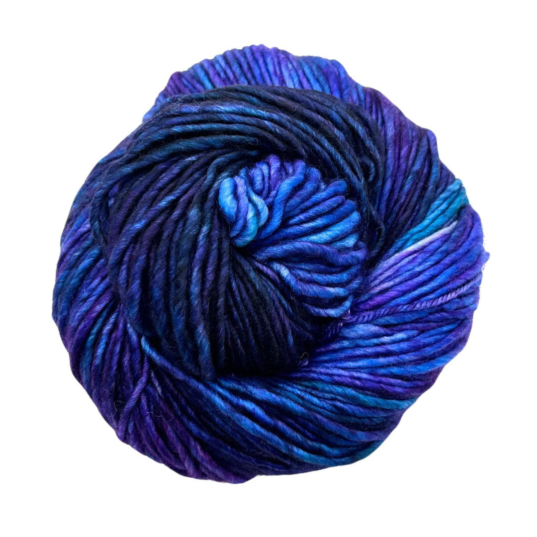 A vibrant skein of yarn in rich shades of blue and purple, tightly wound.