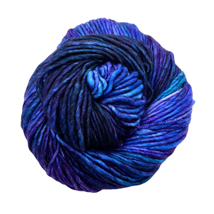 A vibrant skein of yarn in rich shades of blue and purple, tightly wound.