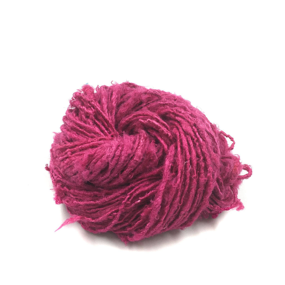 Banana Fiber Yarn donut ball in Rich Magenta on a white background