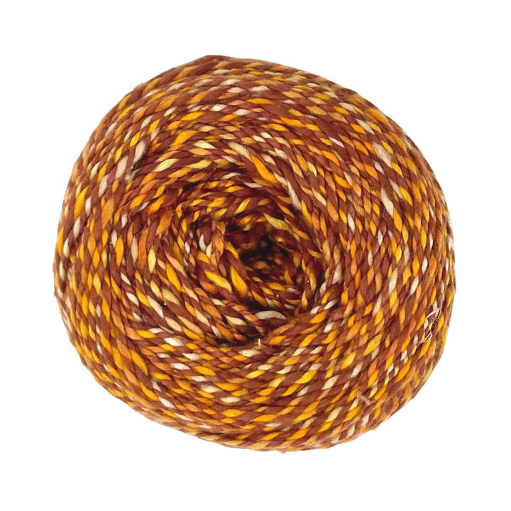 Warm-toned yarn ball with brown, gold, and cream strands.