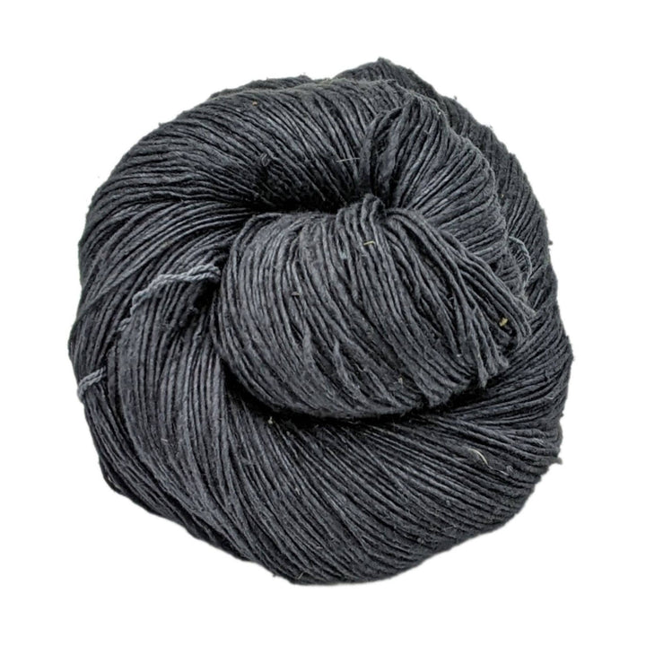 skein of black lace weight silk yarn in front of a white background. 