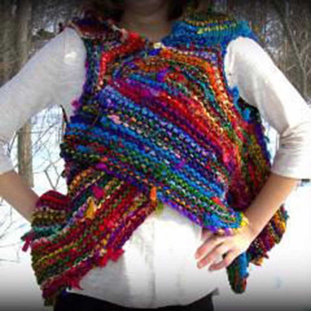 Woman wearing Adventure Cardi vest in multicolor standing in front of a snowy landscape