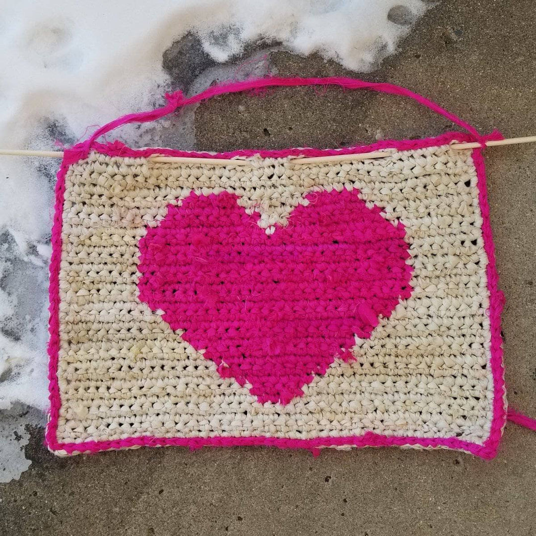All My Love crochet Wall Hanging with hot pink heart sitting on a gray background