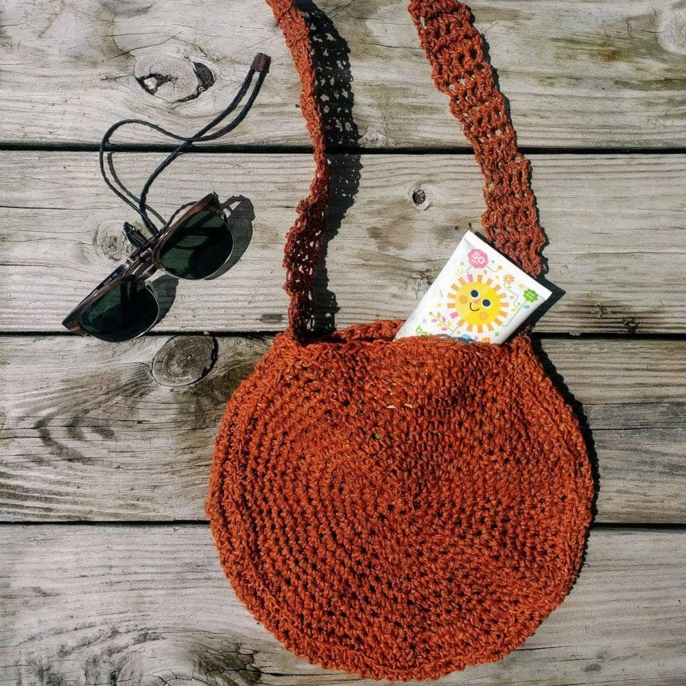 Beach Day Bag Crochet shoulder bag in Rust (burnt orange) on a wooden background
