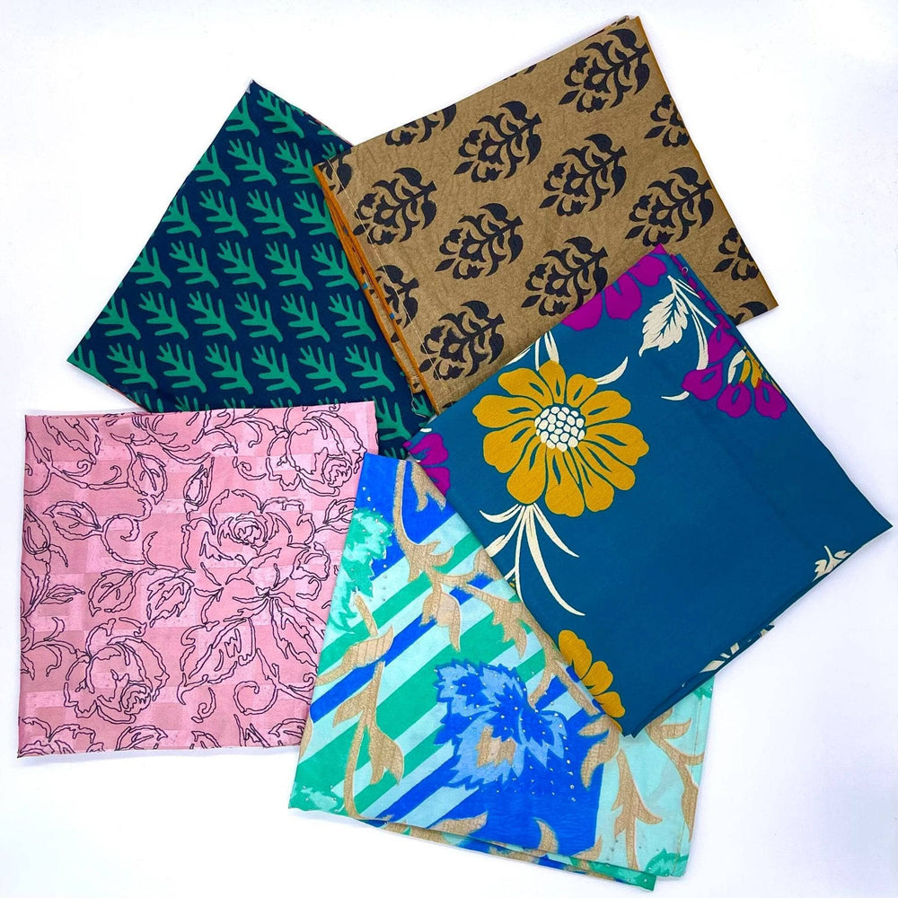 Five reusable sari gift wraps in a circle on a white background. Each wrap is a different pattern and colorway