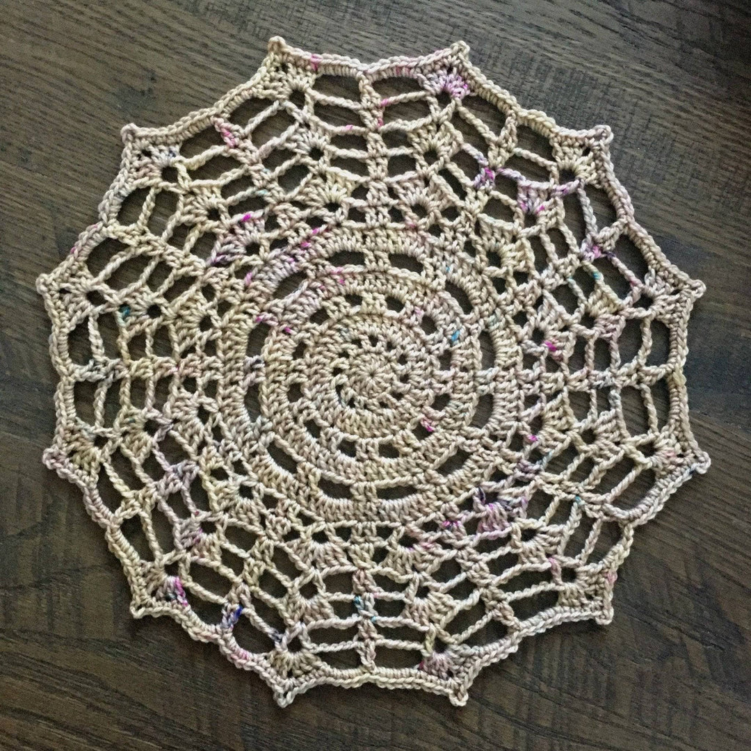 beige doily over a brown table