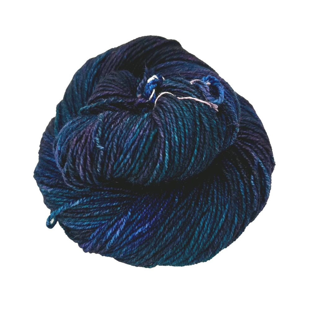 A skein of purple and blue yarn on a white background