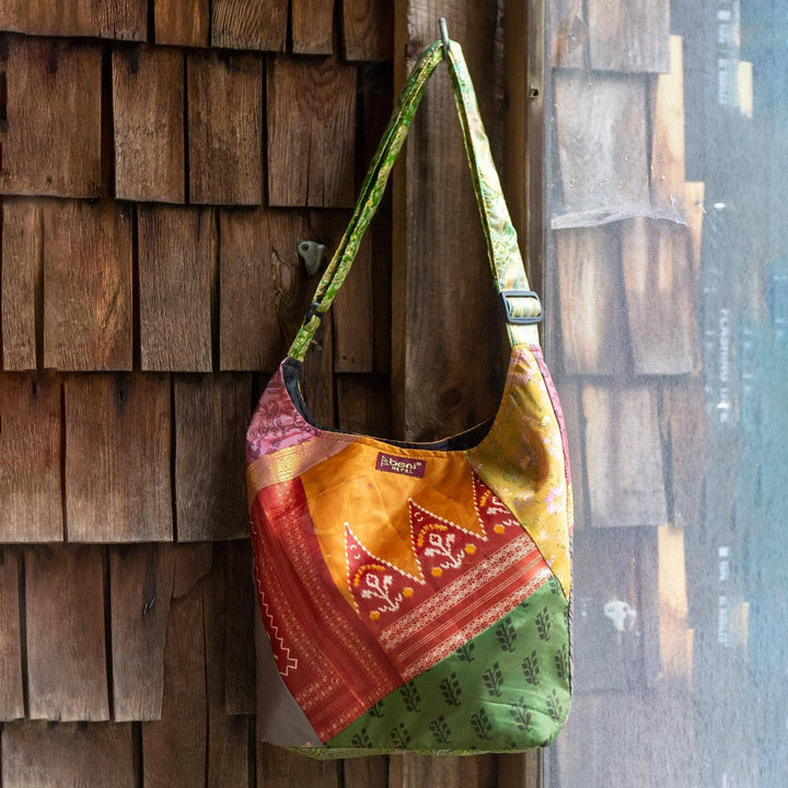 A hanging Sari Silk Purse, showing the length of the strap of the bag.