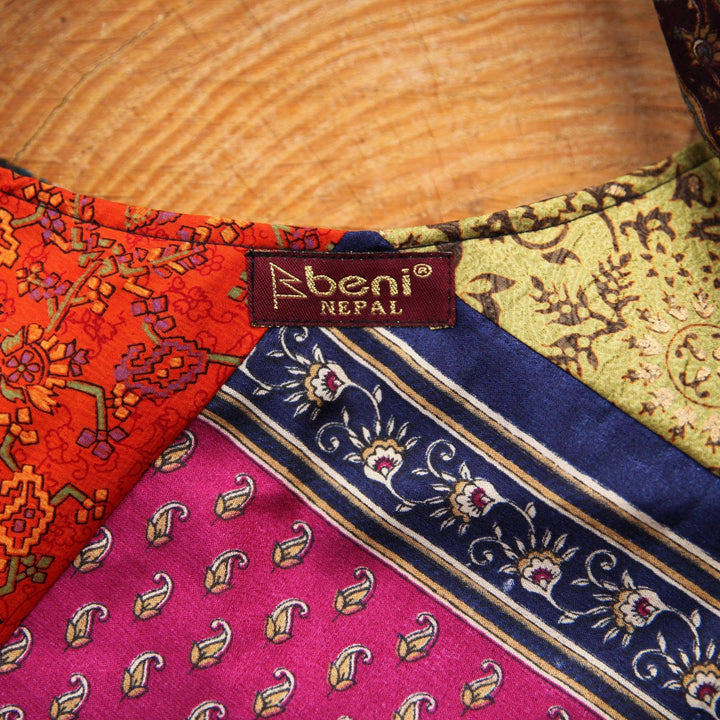 An up-close photo of a Sari Silk Purse, showing some of the detail and the stitching.