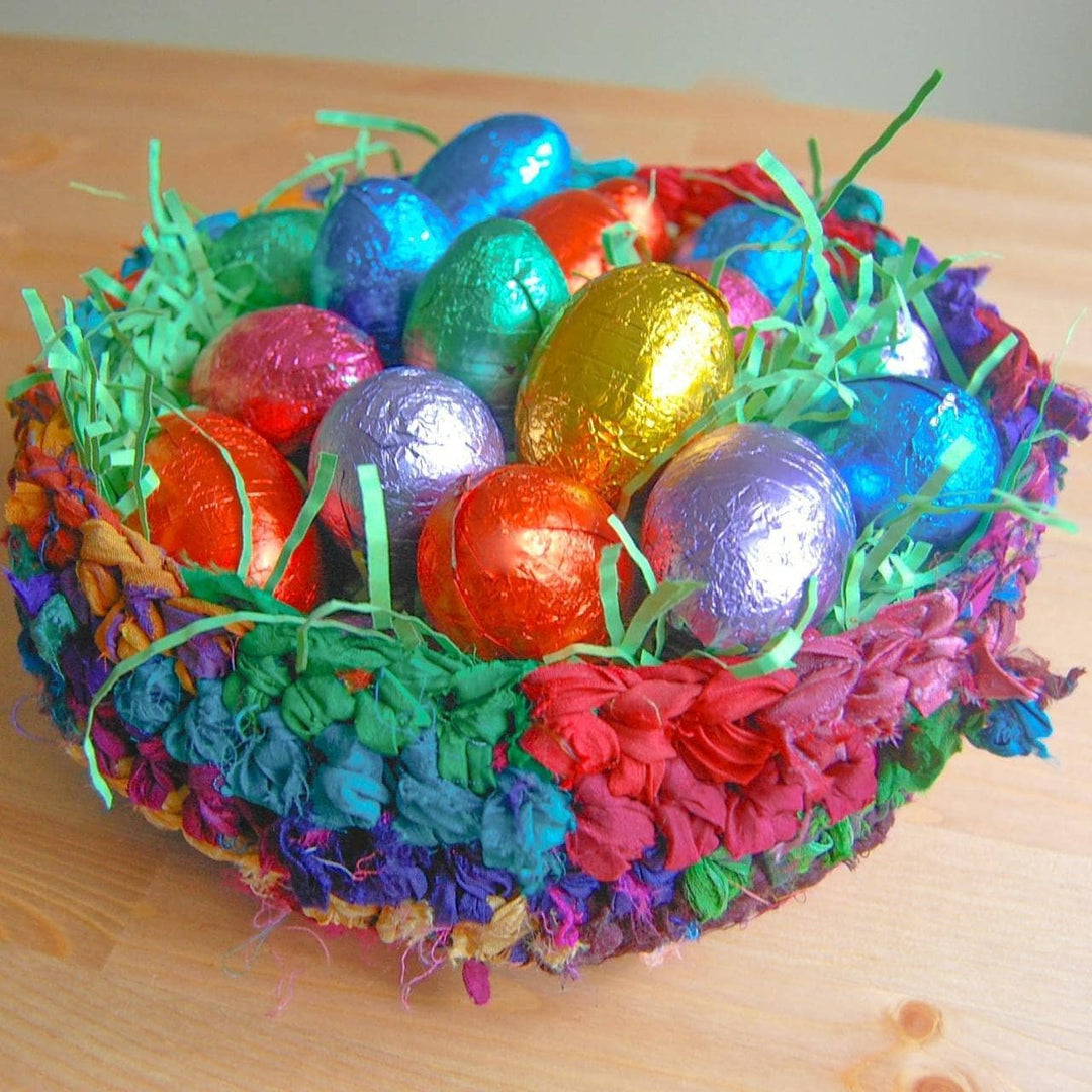 colorful basket of ribbon yarn with confetti and easter eggs inside.