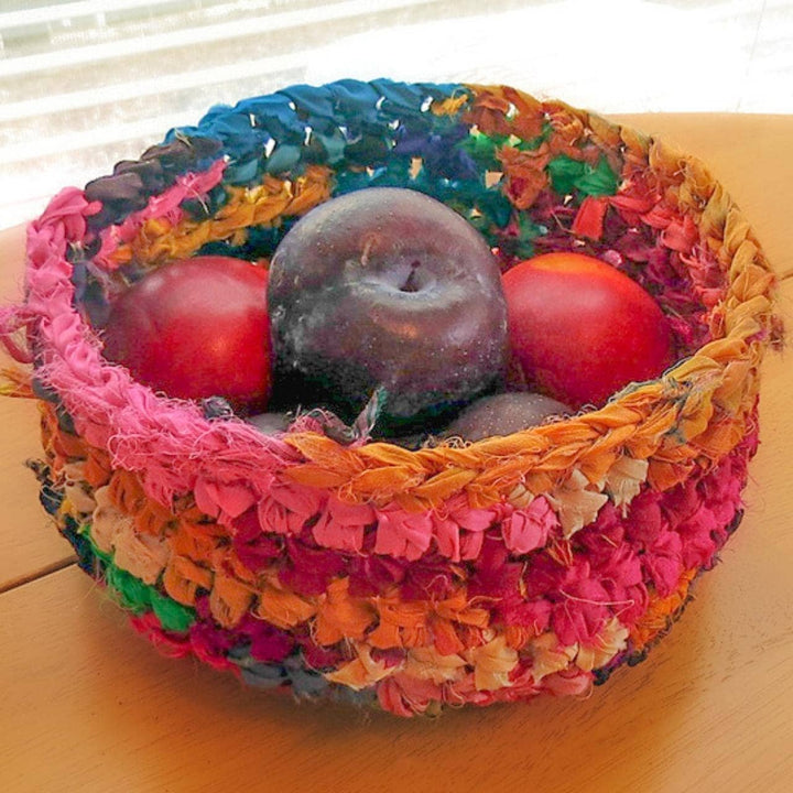 colorful basket of ribbon yarn with fruit inside.