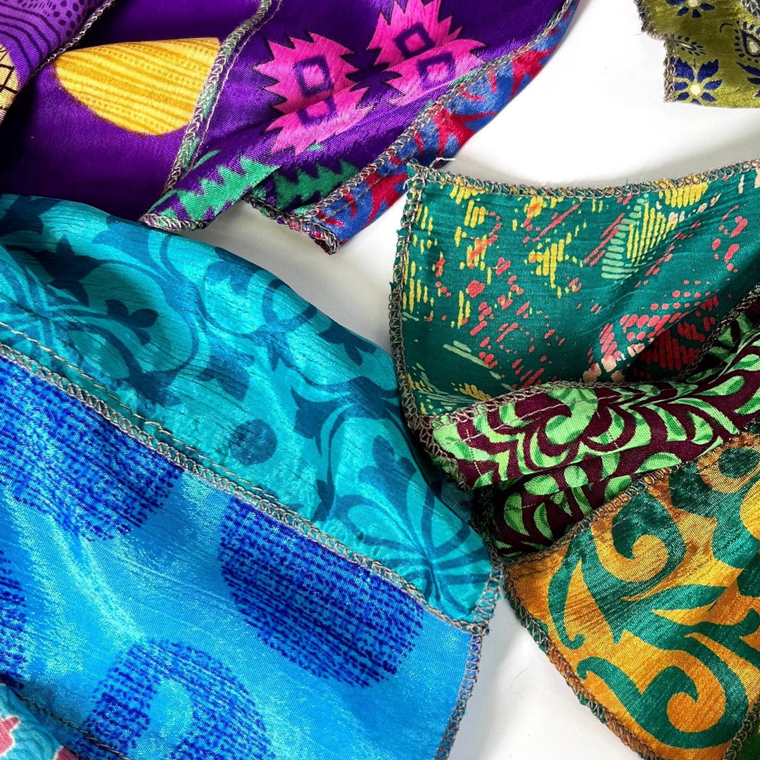 close up on cool toned sari silk medley scarves.