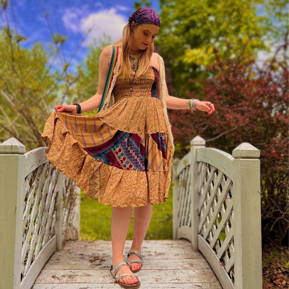 Woman holding the sedona dress to show the pattern and flow of color
