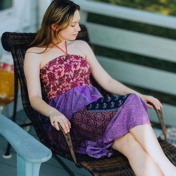 Woman sitting in a chair posing with pink and purple tone sedona dress