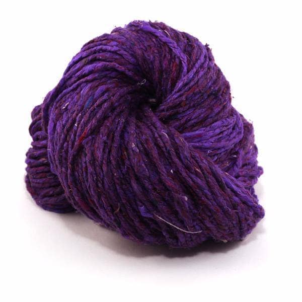 Spekcled Tweed Recycled Silk Yarn ball in Royal Purple on a white background