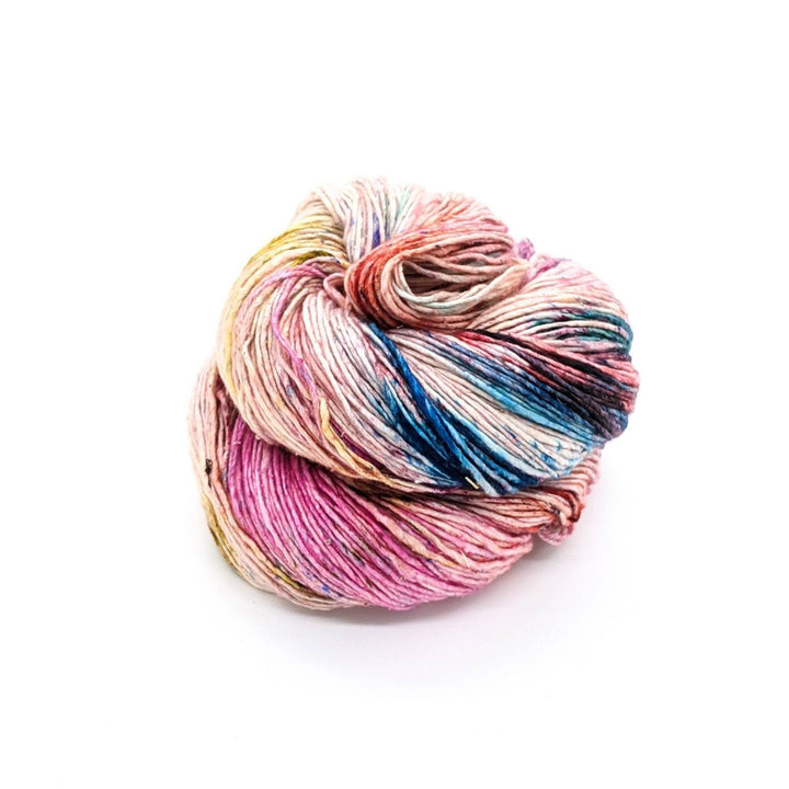 Sport weight silk yarn in Confetti  (pink, yellow, blue and white) in front of white background.