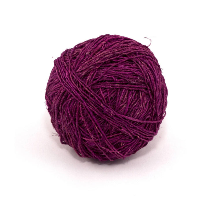 Purple vegan hemp yarn single ply hand spun in front of a white background.