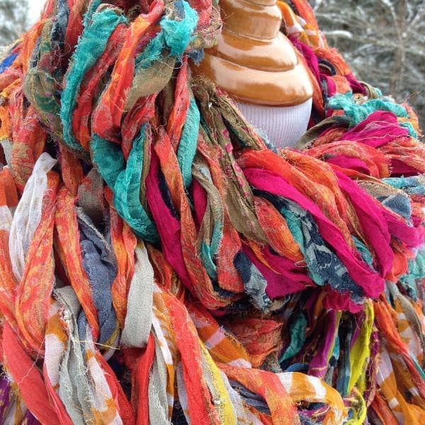 Close up of mannequin wearing 30 Minute Arm Knit Scarf