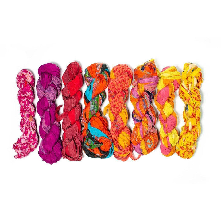 Vibrant braided fabric yarn in red, pink, orange, and yellow hues