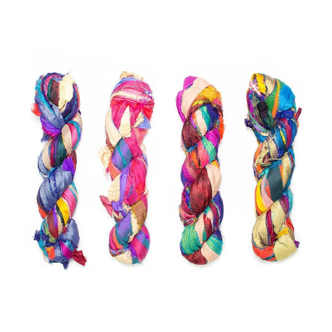 assortment of at the bahamas one of a kind sari silk ribbon yarn in front of a white background.