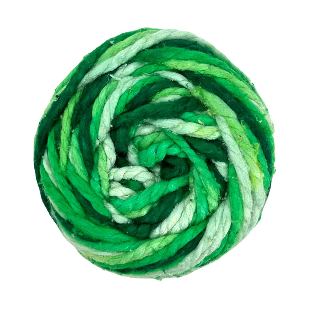 Top-down view of a skein of Worsted Weight Recycled Silk Yarn, featuring an array of green tones. This luxurious yarn, made from 100% recycled silk, offers a soft and silky texture ideal for various crafting projects while promoting sustainability.