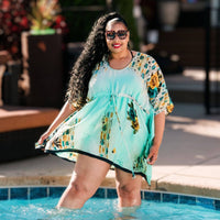 woman in pool wearing short kaftan