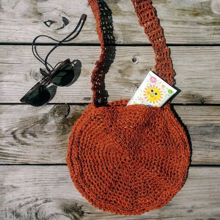 Beach Day Bag Crochet shoulder bag in Rust (burnt orange) on a wooden background