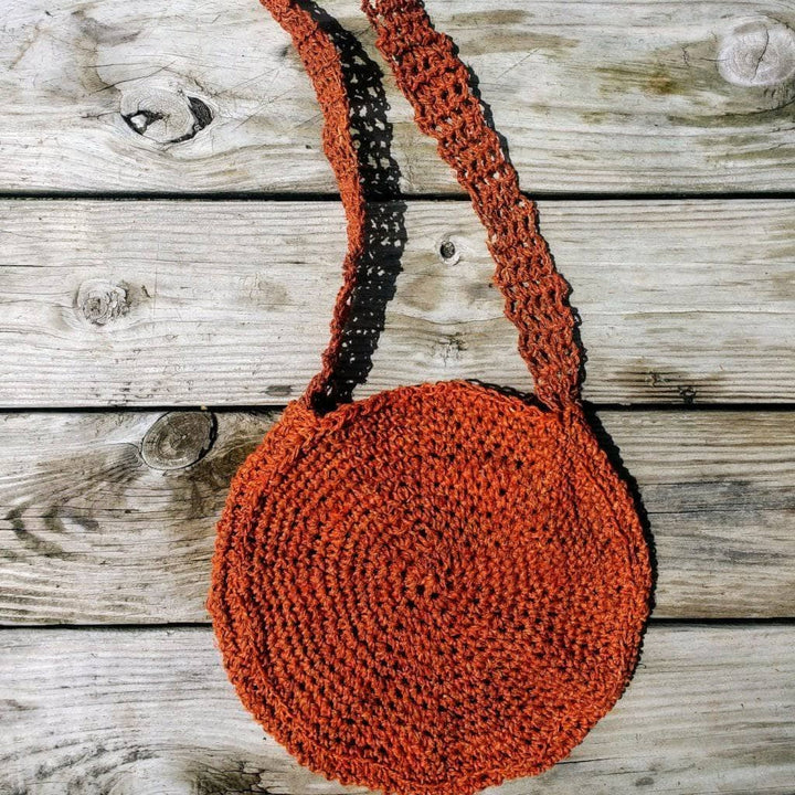 Beach Day Bag Crochet shoulder bag in Rust (burnt orange) on a wooden background