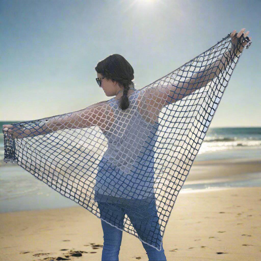Woman holding a Blue Jay Triangle Scarf behind her back and standing in front of a white wall