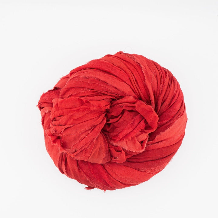 A rolled red chiffon ribbon.