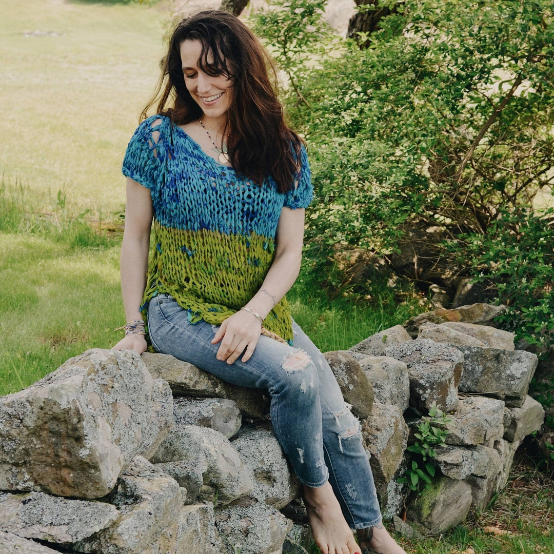 model wearing blue and green summer top made from recycled ribbon yarn