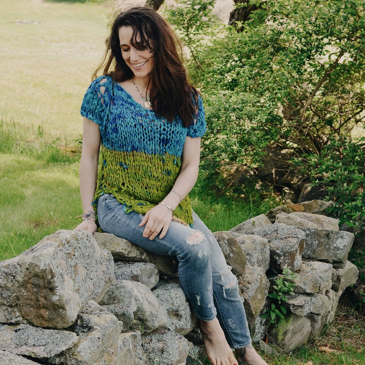model wearing blue and green summer top made from recycled ribbon yarn