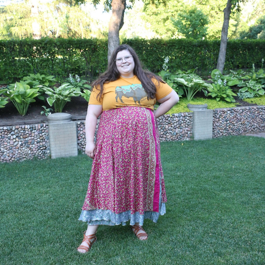 Model is outside wearing one of a kind pink goddess ankle sari wrap skirt.