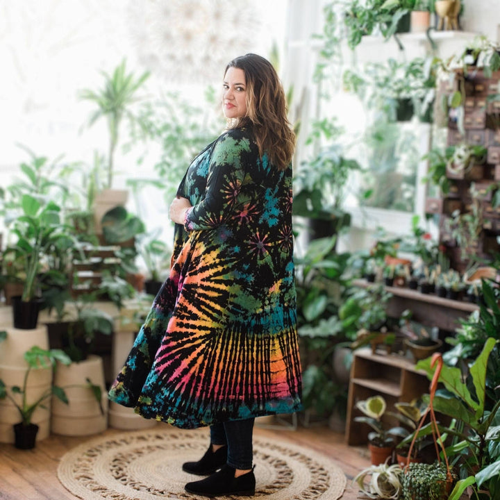 A woman sanding wearing cotton tie dye long cardigan.