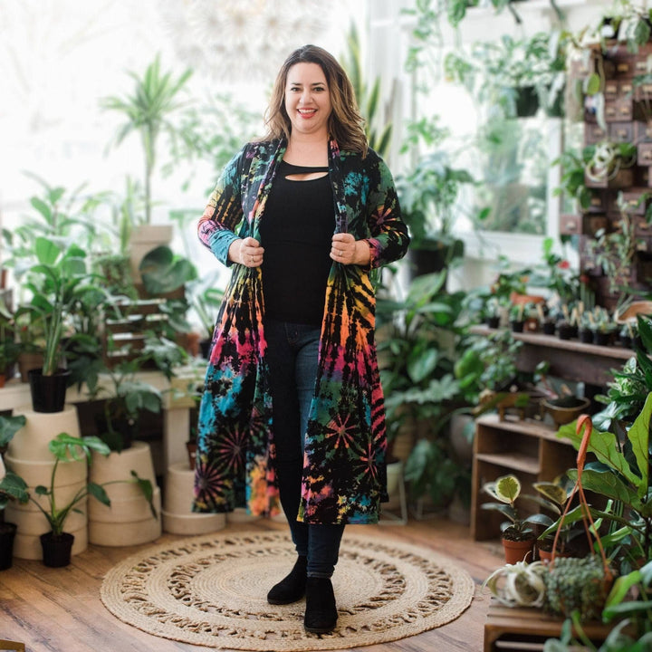 A woman sanding wearing cotton tie dye long cardigan.