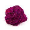 Silk yarn donut ball in Crimson Rose (hot pink) on a white background