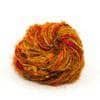 Silk yarn donut ball in Sunflower (deep yellow) on a white background