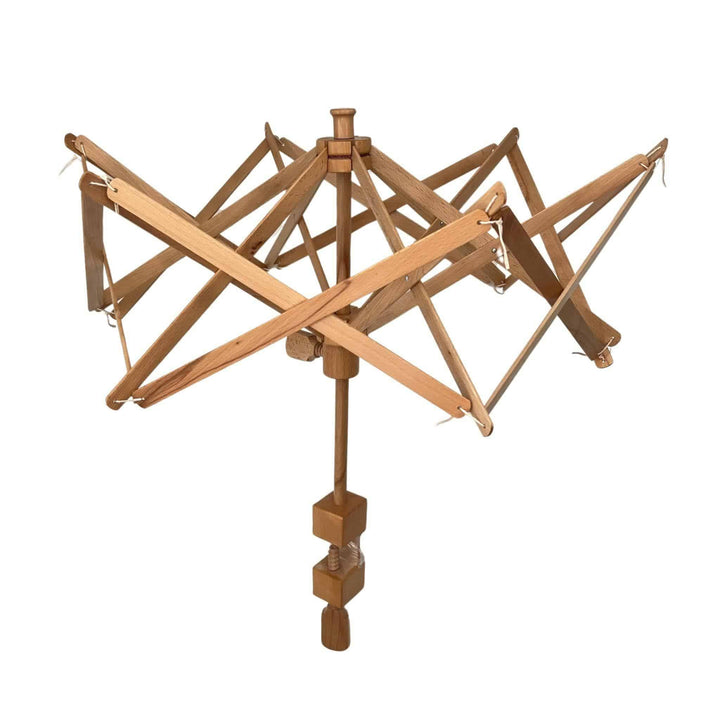 A wooden yarn swift with an expandable umbrella-like structure, used for holding skeins of yarn while winding them into balls.