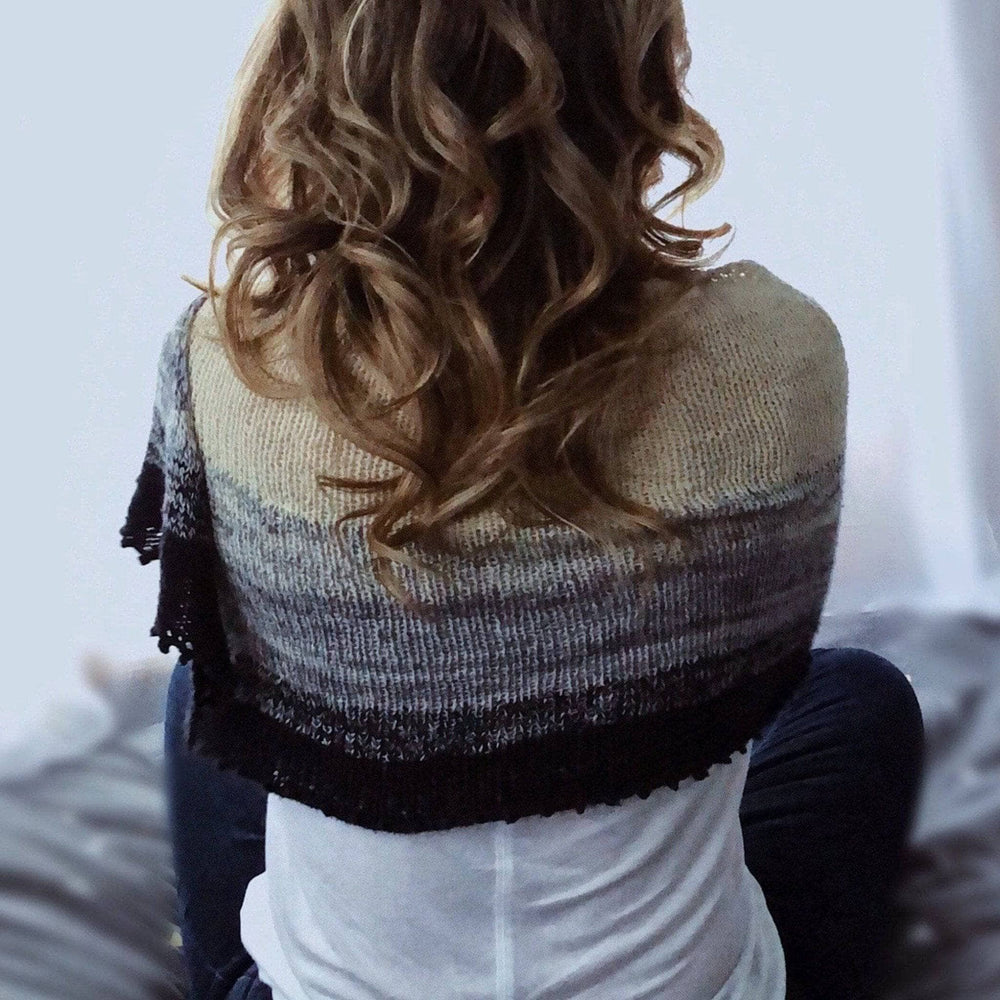 Back of women wearing Fernweh Shawl  in black and white ombre. 