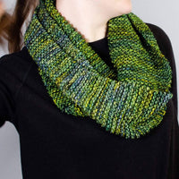 a women wearing a black shirt with jean wearing a green scarf