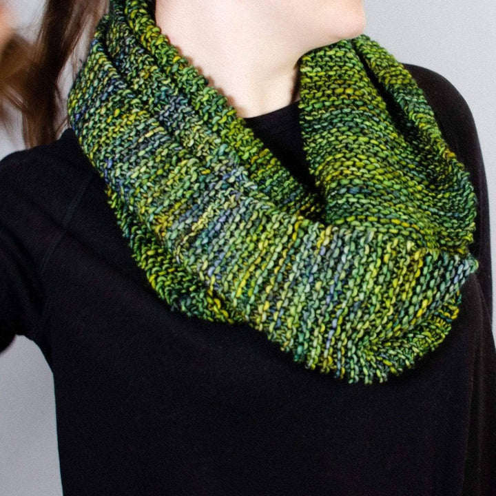 a women wearing a black shirt with jean wearing a green scarf