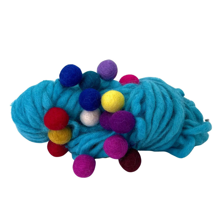 Cyan Felt Ball Wool Yarn on a white background. The felt balls are rainbow colors.
