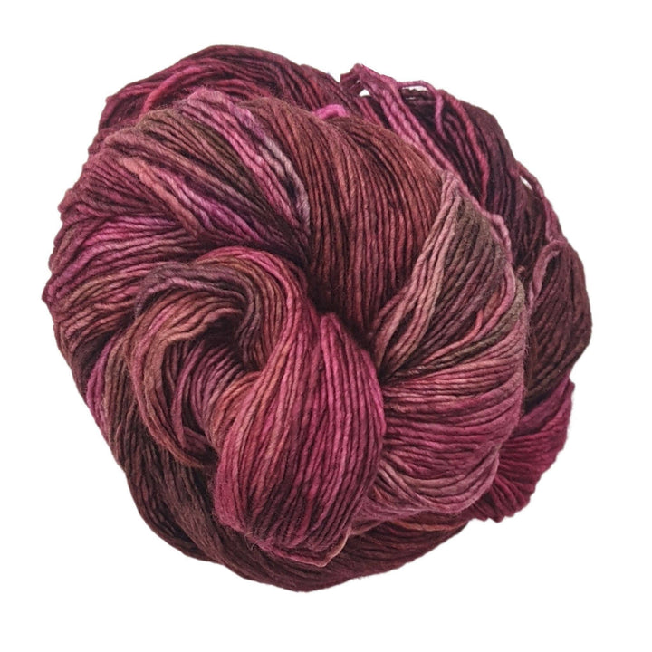 tonal red yarn in front of a white background.