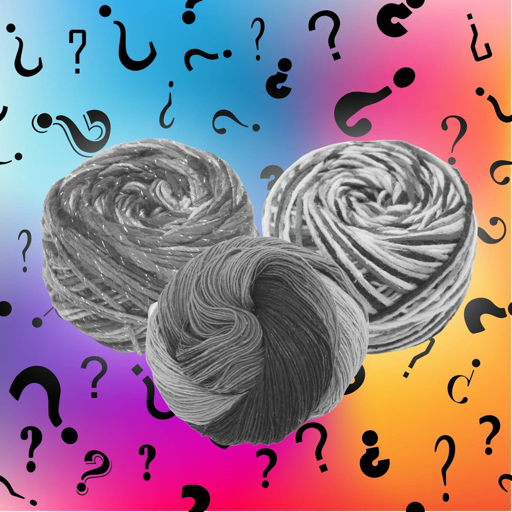3 skeins of yarn shown in black and white in front of a multicolor background with question marks in different fonts and orientations.