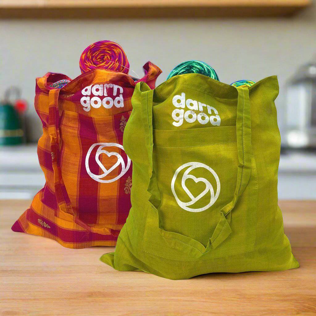 Two Sari Silk Market Totes filled with Yarn, sitting on a white background.
