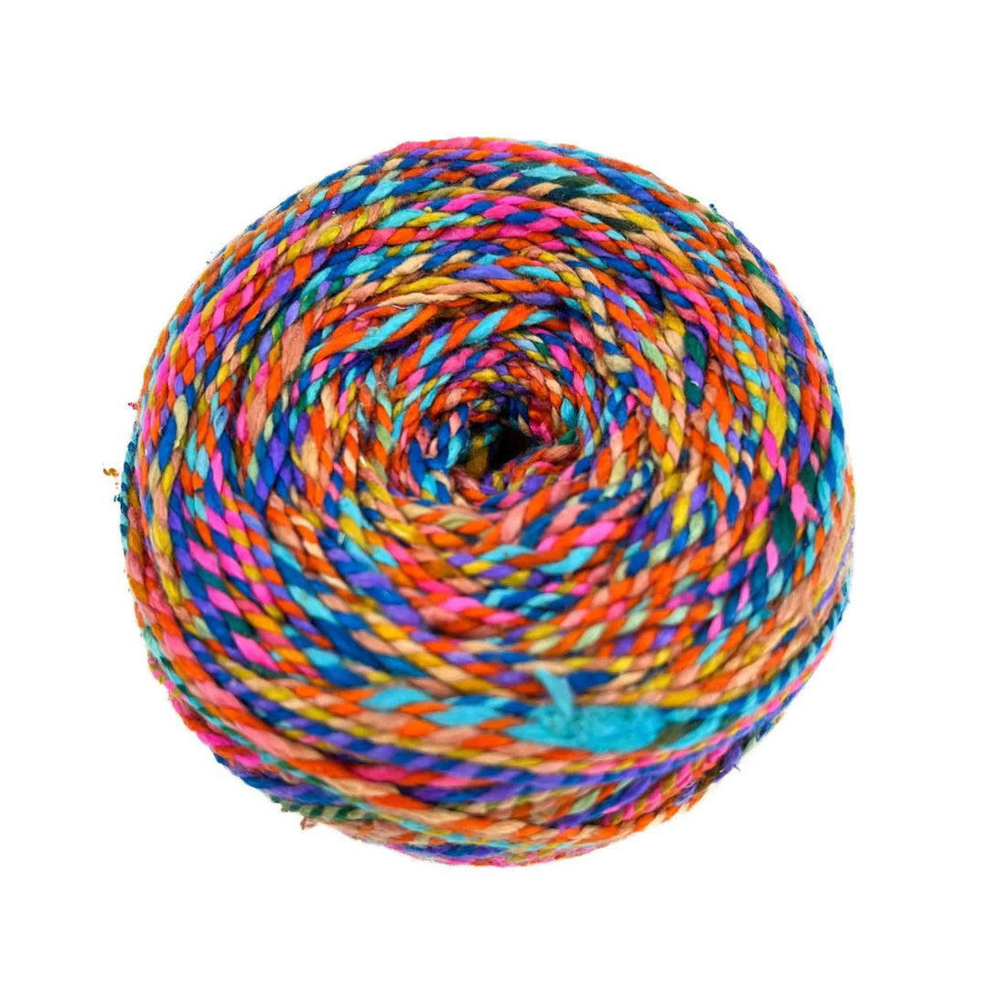 A multi-colored rolled lace weight yarn.