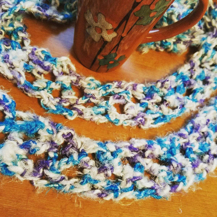 scarf laying over a brown table 