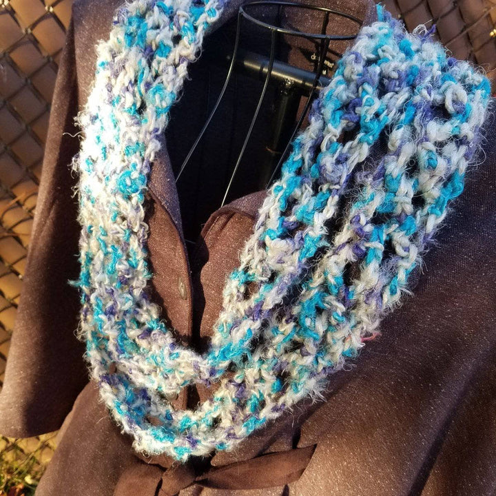 scarf hanging over a brown jacket