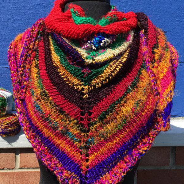 colorful red yellow blue and brown shawl over a mannequin
